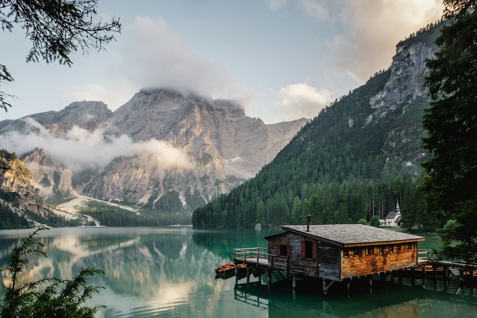 A quiet lakeside cabin surrounded by mountains and open water